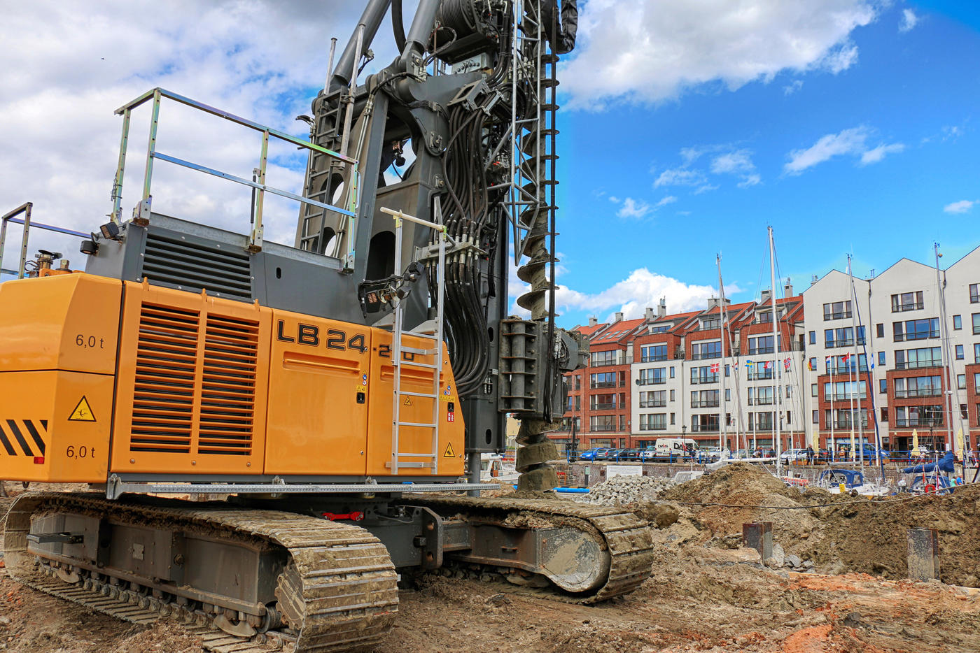 The excavation for two underground storeys was made with the use of diaphragm walls and the floor-slab method. A Soilcrete filter screen was used at the bottom of the excavation located about 6 m below the groundwater table. Temporary pillars of the ceiling served as anchoring elements preventing water displacement. Due to the old walls limiting access for large drilling rigs necessary for CFA piles, the type of piles in this area was changed to micro-injection piles made with smaller equipment located betw