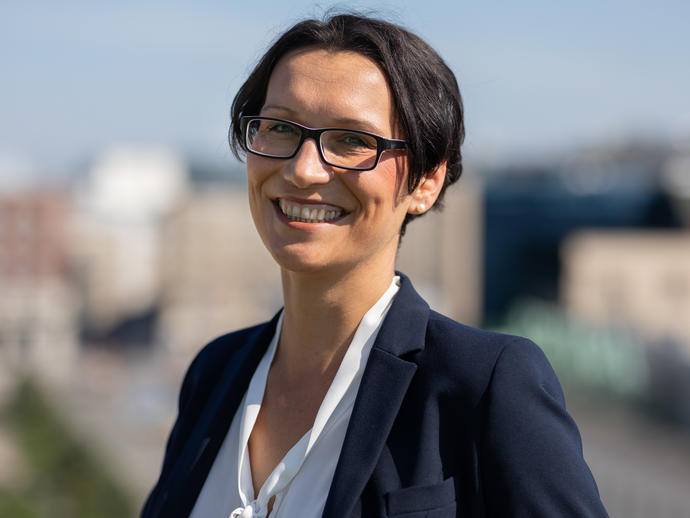 female employee in suit smiling