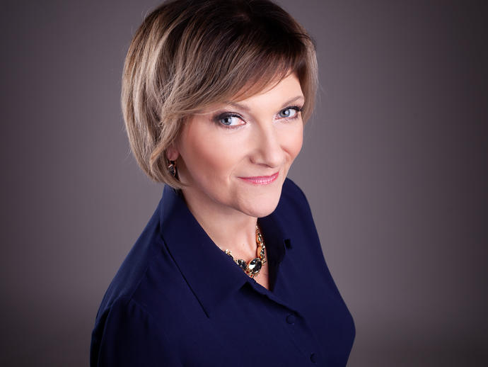 woman smiling wearing blue top headshot