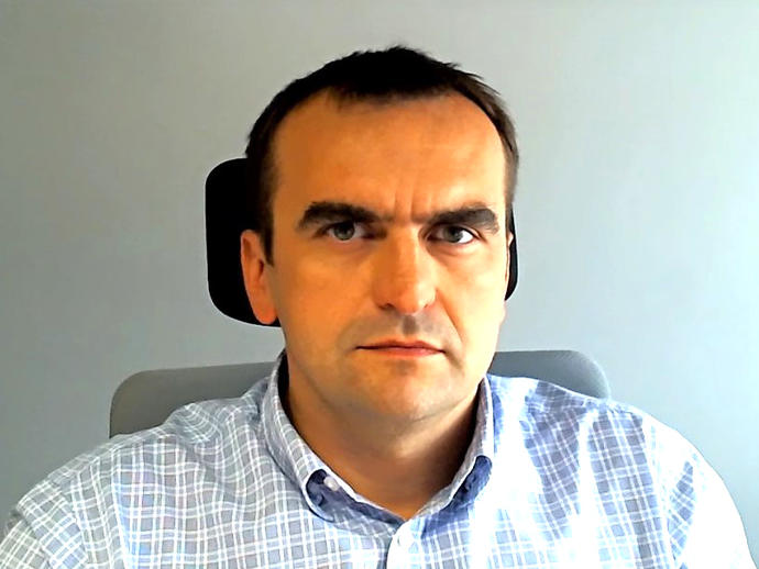 head shot of man sitting in office chair